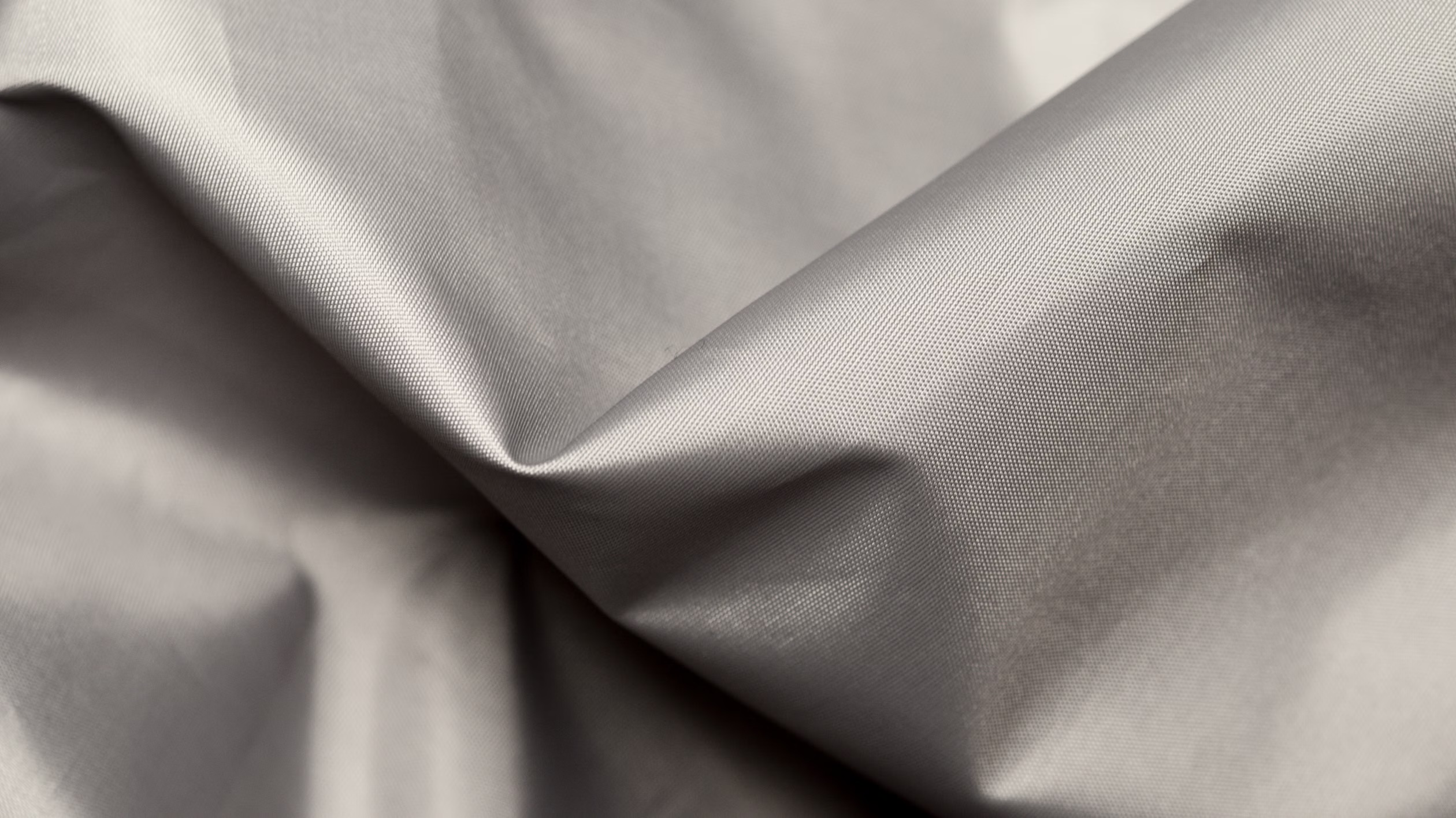 Close-up reference photograph of smooth grey fabric folds by Artem Podrez, Pexels